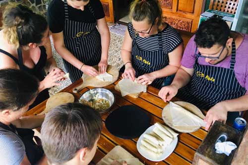 Preparing spring rolls at Thai cooking class